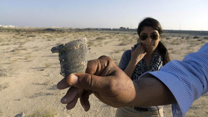 Archaeologists and students have unearthed traces of occupation on Saadiyat Island. Dr Anjana Lingareddy, an archaeologist with Abu Dhabi Tourism and Culture Authority, looks at a potsherd from the late 18th and early 19th centuries. Courtesy Dr Robert Parthesius