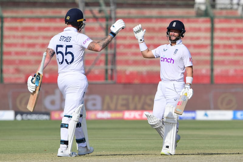 England's Ben Duckett and Ben Stokes celebrate the eight-wicket victory on Day 4 at the National Stadium in Karachi. AFP