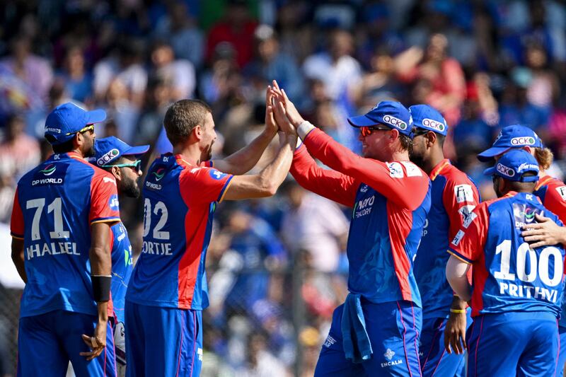 Delhi Capitals' Anrich Nortje celebrates with teammates after taking the wicket of Mumbai Indians' Suryakumar Yadav for a duck. AFP