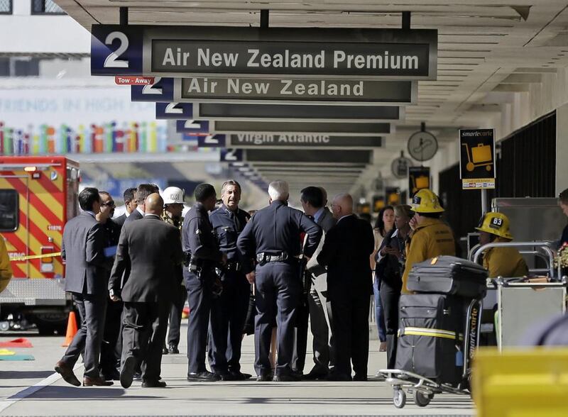 Los Angeles police chief Charlie Beck talks with other responders at Los Angeles International Airport on Friday after shots were fired in Terminal 3, prompting authorities to evacuate the terminal and stop flights headed for the city from taking off from other airports. Reed Saxon / AP Photo