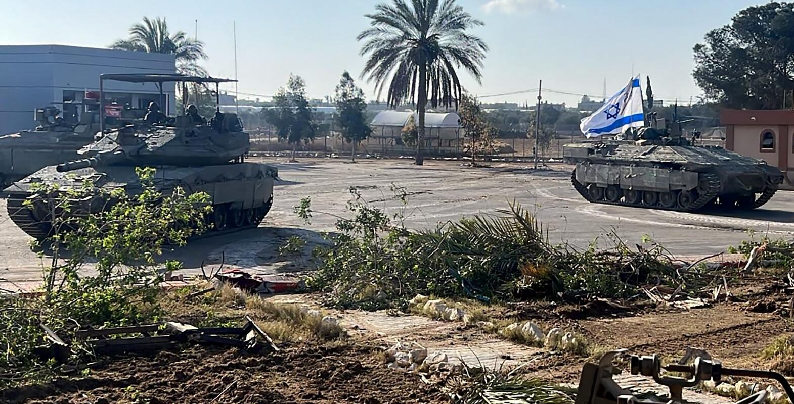 TOPSHOT - This handout picture released by the Israeli army shows the 401st Brigade's combat team tanks entering the Palestinian side of the Rafah border crossing between Gaza and Egypt in the southern Gaza Strip on May 7, 2024.  The Israeli army said it took "operational control" of the Palestinian side of the Rafah border crossing on May 7 and that troops were scanning the area.  (Photo by Israeli Army  /  AFP)  /  === RESTRICTED TO EDITORIAL USE - MANDATORY CREDIT "AFP PHOTO  /  Handout  /  Israeli Army' - NO MARKETING NO ADVERTISING CAMPAIGNS - DISTRIBUTED AS A SERVICE TO CLIENTS ==