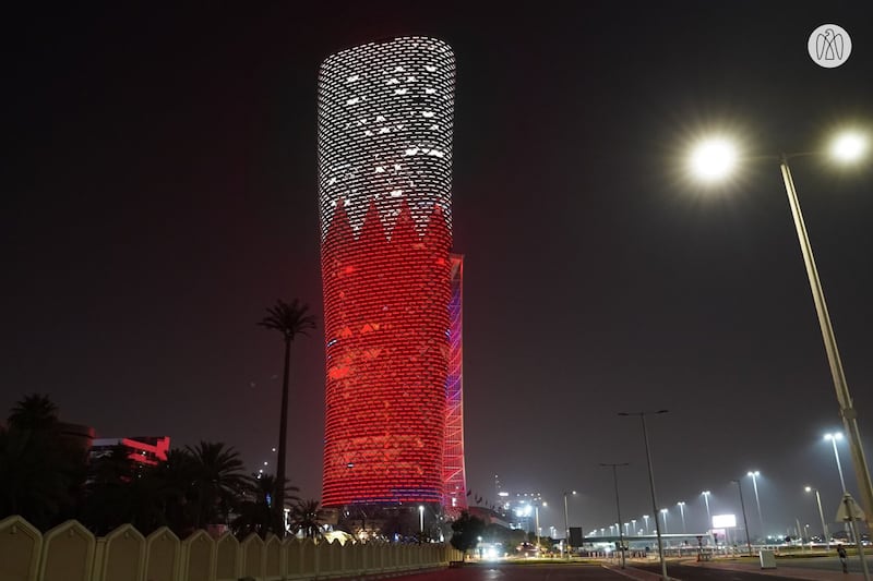 Adnec's Capital Gate building in Abu Dhabi is lit up with the colours and design of the Bahrain flag.
