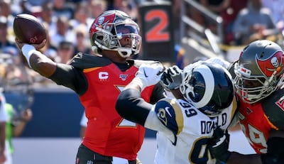 Sep 29, 2019; Los Angeles, CA, USA; Tampa Bay Buccaneers quarterback Jameis Winston (3) throws a pass under pressure from Los Angeles Rams defensive tackle Aaron Donald (99) during the second quarter at Los Angeles Memorial Coliseum. Blocking against Donald is Buccaneers offensive tackle Demar Dotson (69). Mandatory Credit: Robert Hanashiro-USA TODAY Sports