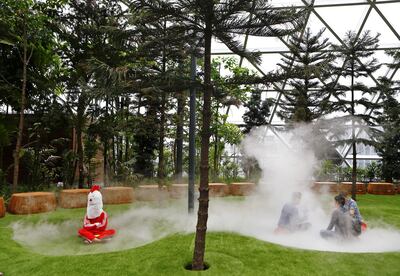 A man in a chicken costume sits in mist inside Jewel Changi Airport in Singapore, April 11, 2019. REUTERS/Feline Lim