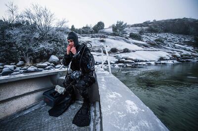 Lotta Klemming, a professional oyster diver, prepares for a dive, near her family’s company in Grebbestad in Vastra Gotaland county on Sweden’s west coast on January 31, 2021. Klemming left a career in the fashion industry in Sweden to return to her family’s home, taking up diving for wild oysters as a business, selling the distinctive-flavored seafood to restaurants  around Sweden and enjoying the feeling of being close to nature in the area where she grew up. - TO GO WITH AFP STORY BY TOM LITTLE
 / AFP / Jonathan NACKSTRAND / TO GO WITH AFP STORY BY TOM LITTLE
