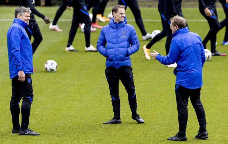 Netherlands' head coach Frank de Boer, centre, and his assistant Dwight Lodewege, right, take part in a training session. AFP
