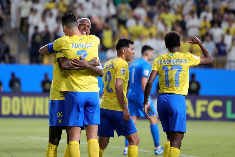 Al Nassr forward Talisca celebrates with Cristiano Ronaldo after scoring the opening goal against Al Duhail. AFP