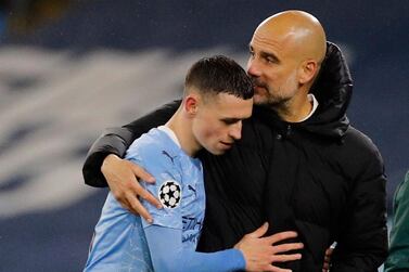 Pep Guardiola hugs Phil Foden as he is substituted in the closing stages of Manchester City's semi-final win over PSG. Reuters