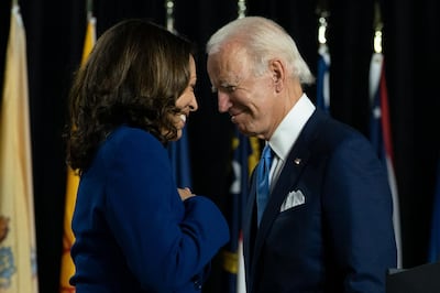 Democratic presidential candidate former Vice President Joe Biden and his running mate Sen. Kamala Harris, D-Calif., pass each other as Harris moves to the podium to speak during a campaign event at Alexis Dupont High School in Wilmington, Del., Wednesday, Aug. 12, 2020. (AP Photo/Carolyn Kaster)