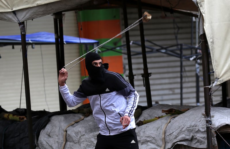 A Palestinian uses a sling in clashes with Israeli troops. EPA