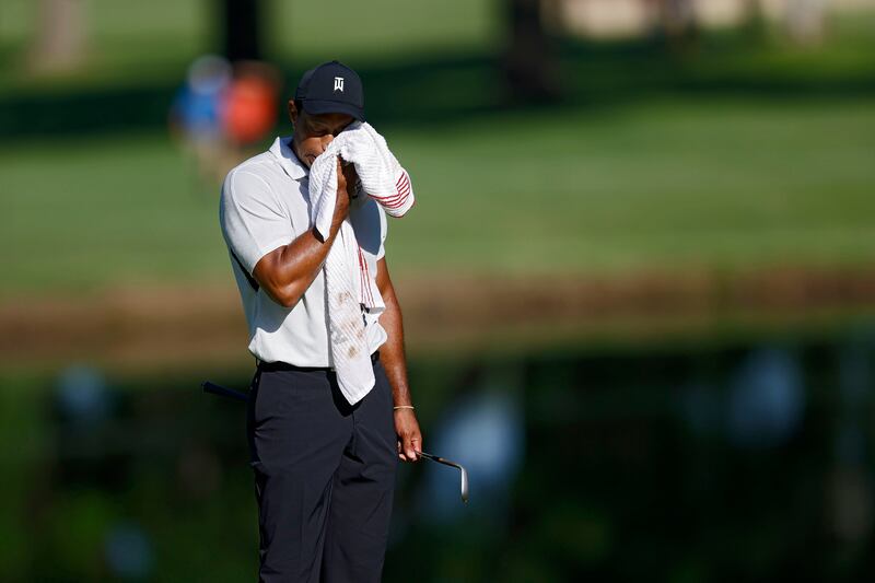 Tiger Woods wipes his face on the 11th green during a practice round for the PGA Championship. AP