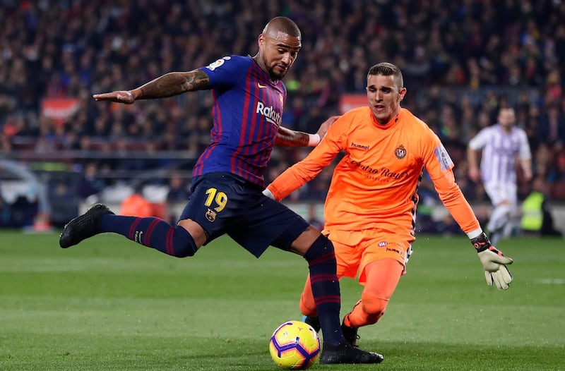 Barcelona's Kevin-Prince Boateng duels for the ball with Real Valladolid's Jordi Masip. AP Photo