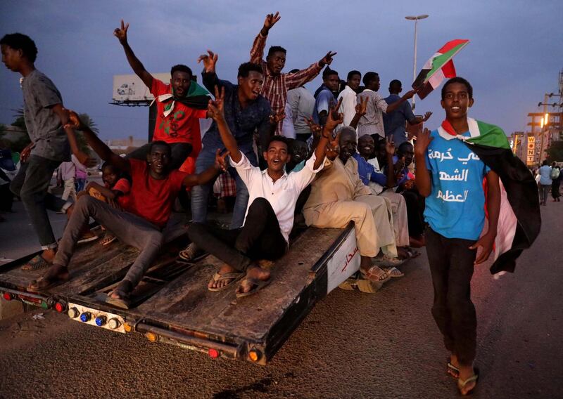 Sudanese people celebrate after the signature of the power sharing agreement between the opposition and the military in Khartoum, Sudan.  EPA/MORWAN ALI