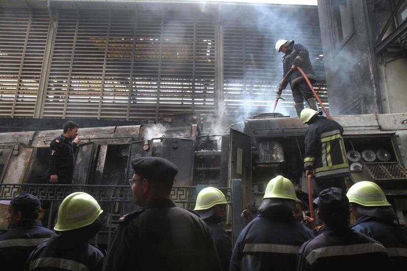 A fire fighter extinguishes flames at the scene of a fiery train crash at the Egyptian capital Cairo's main railway station on February 27, 2019. - The crash killed at least 20 people, Egyptian security and medical sources said.
The accident, which sparked a major blaze at the Ramses station, also injured 40 others, the sources said. (Photo by STRINGER / AFP)