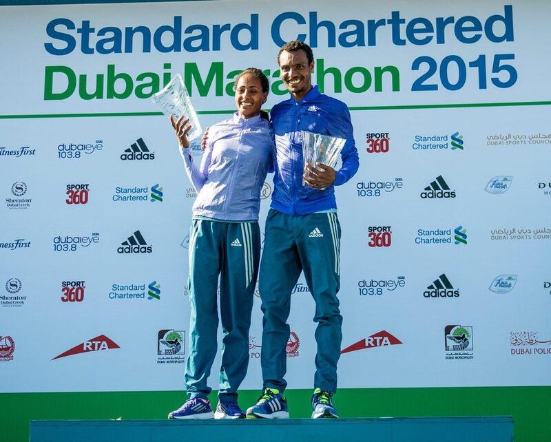 Ethiopian women's Dubai Marathon winner Aselefech Mergia, left, and Ethiopian men's winner Lemi Berhanu Hayle, right, pose with their trophies after the 2015 Dubai Marathon on Friday. Stephen Hindley / AP