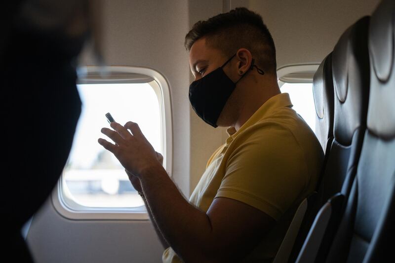 A passenger wearing a protective mask uses a mobile phone before an Avelo Airlines flight at Charles M. Schulz–Sonoma County Airport (STS) in Santa Rosa, California, U.S., on Wednesday, April 28, 2021. New money is flowing to low-cost airlines in the U.S. as they take on giant carriers racing to recover from the unprecedented collapse in travel during the pandemic. Photographer: Bing Guan/Bloomberg