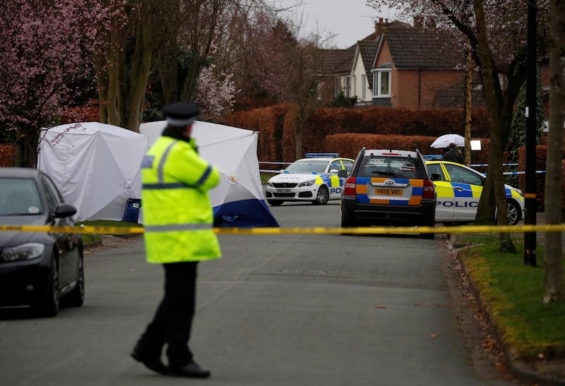 Police officers stand in front of a protective tent at the location where a 17-year-old boy was fatally stabbed in Hale Barns, Britain, March 3, 2019. REUTERS/Phil Noble