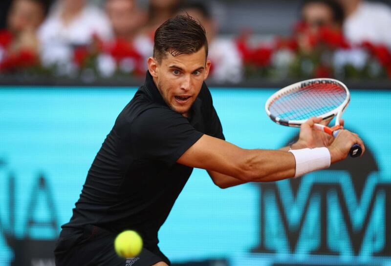 MADRID, SPAIN - MAY 11:  Dominic Thiem of Austria plays a backhand against Rafael Nadal of Spain in their quarter final match during day seven of the Mutua Madrid Open tennis tournament at the Caja Magica  on May 11, 2018 in Madrid, Spain.  (Photo by Clive Brunskill/Getty Images)