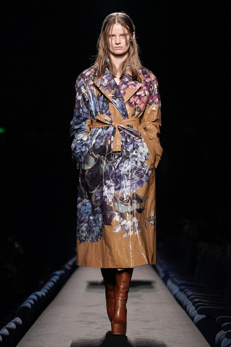 Flowers decorate a trench coat at Dries Van Noten 