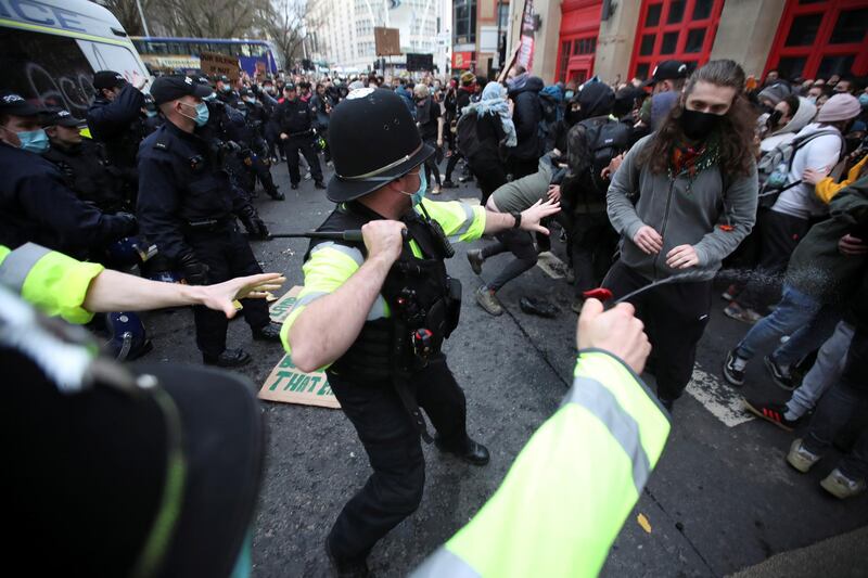 A police officer uses pepper spray during the demonstration in Bristol. Reuters