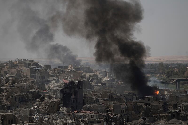 Smoke billows from Islamic State positions on the edge of the Old City a day after Iraq's prime minister declared "total victory" in Mosul