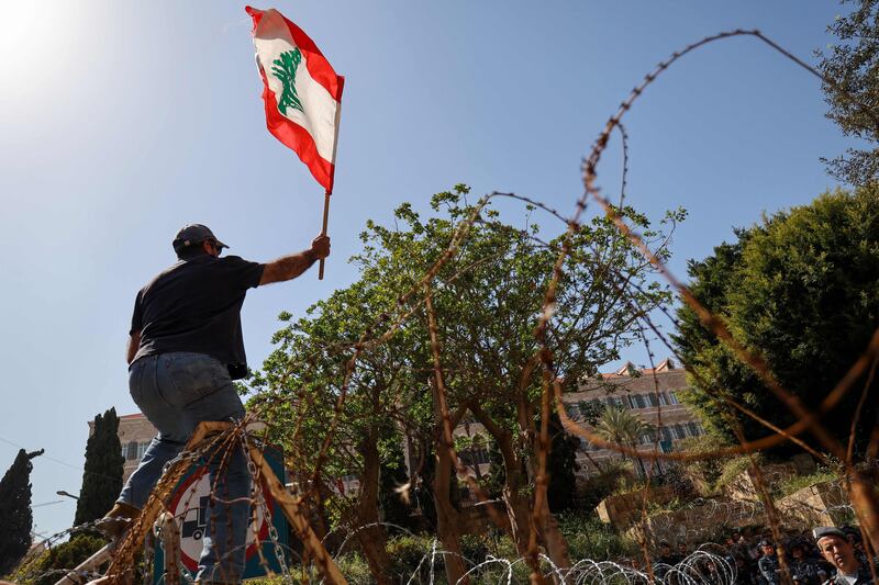 A Lebanese demonstrator waves his country's national flag. AFP
