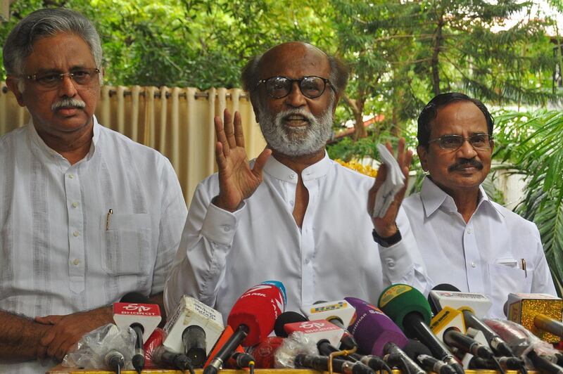 Indian actor Rajinikanth (C) addresses the media representatives in front of his residence in Chennai on December 3, 2020. Indian film superstar Rajinikanth announced on December 3 that he is going into politics vowing to bring in "corruption-free" politics. / AFP / -
