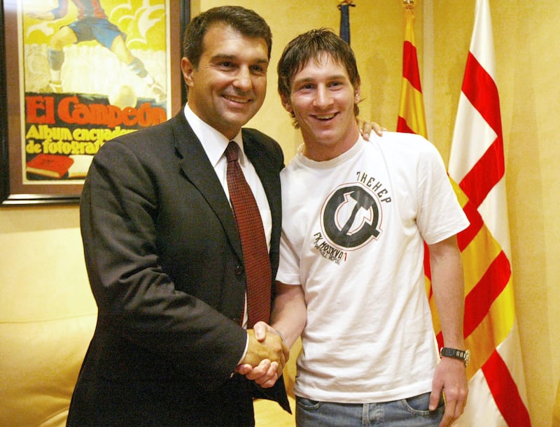 Hand out photograph of Barcelona's Argentinian football player Lioneleo Messi (R) shaking hands with FC Barcelona's President Joan Laporta (L) dated 16 September 2005 after Messi extended his contract until 2014 at Nou Camp Stadium in Barcelona. Messi has reached an agreement for the extension of the Argentinean player's contract until 30 June 2014, and includes a 150 million euro buyout clause.  
AFP PHOTO FCBARCELONA.COM (Photo by FCBARCELONA.COM / FCBARCELONA.COM / AFP)