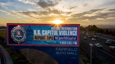 In a photo taken with a drone, a billboard seeking tips about "Stop The Steal" protesters who breached the United States Capitol Building stands in Fairfield, Calif., on Friday, Jan. 15, 2021. (AP Photo/Noah Berger)