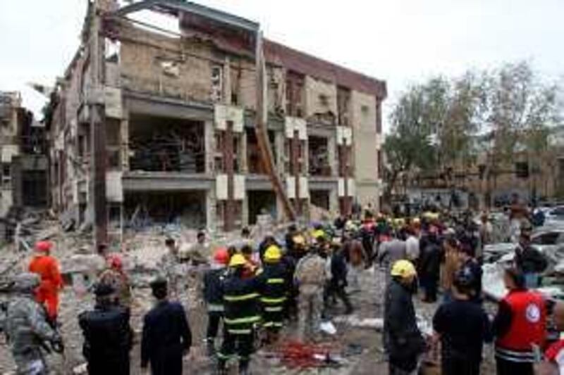 Iraqi rescue workers and firemen gather at the site of a bomb blast outside a criminal court building in west Baghdad's Mansur district on December 8, 2009. Five powerful car bombs rocked Baghdad, killing 112 people, including women and students, and wounding 207 in the third co-ordinated massacre to devastate the capital since August. AFP PHOTO/ALI AL-SAADI