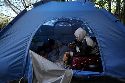 Grace Enjei, 24, right, and Daniel Ejuba, 20, migrants from Cameroon, have lived in this tent in the UN-controlled buffer zone cutting across Nicosia, the capital of divided Cyprus, since trying to cross into Cyprus from the island's breakaway Turkish Cypriot north about six months ago. AP Photo