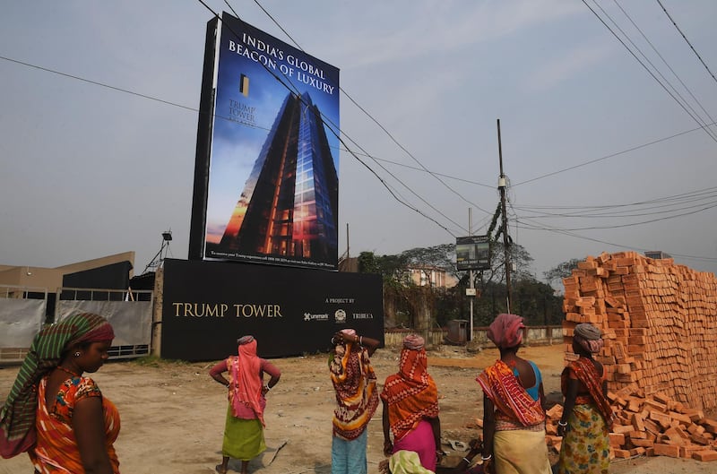 Indian labourers work on the road leading to the under-construction Trump Tower in Kolkata. Dibyangshu Sarkar / AFP
