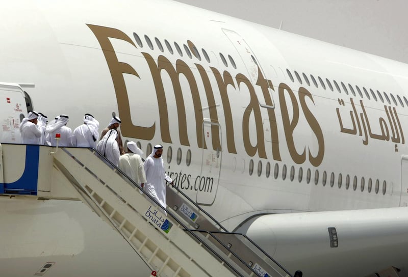 Sheikh Mohammed bin Rashid al-Maktoum (front), prime minister of the United Arab Emirates and the ruler of Dubai, walks off an Emirates Airlines plane during the media tour of Dubai's new second airport, Dubai World Central or Al-Maktoum International, operational only to cargo until passenger facilities are completed, on July 1, 2010, in the desert on the outskirts of the Gulf emirate, where a 32 million dollar (26 million euro) new "city" is being built to include a port.  AFP PHOTO/KARIM SAHIB (Photo by KARIM SAHIB / AFP)