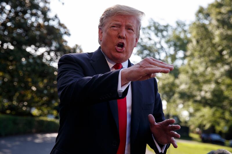 In this May 30, 2019, photo, President Donald Trump talks with reporters on the South Lawn of the White House in Washington. (AP Photo/Evan Vucci)