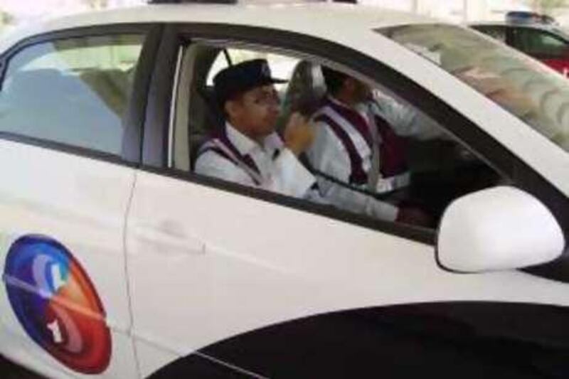 Two employees of Saeed in a patrol car.

Credit: Abu Dhabi Police Department