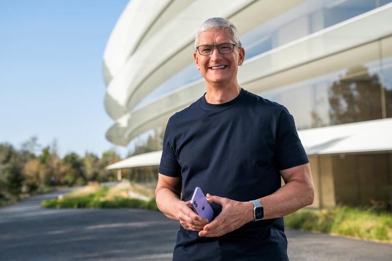 Apple CEO Tim Cook holds an iPhone 12 in a new purple finish during the keynote video of a special event at Apple Park. Reuters