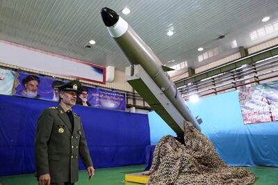 A handout picture released by Iran's Defence Ministry on August 13, 2018 shows Defence Minister, Brigadier General Amir Hatami, standing by the next generation short-range ballistic missile  "Fateh Mobin", during an unveiling ceremony in the capital Tehran. - State broadcaster IRIB said the new missile had "successfully passed its tests" and could strike targets on land and sea. (Photo by - / IRANIAN DEFENCE MINISTRY / AFP)