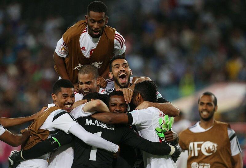 UAE players celebrate after beating Japan on penalties in their Asian Cup quarter-final match on Friday. Craig Golding / AFP