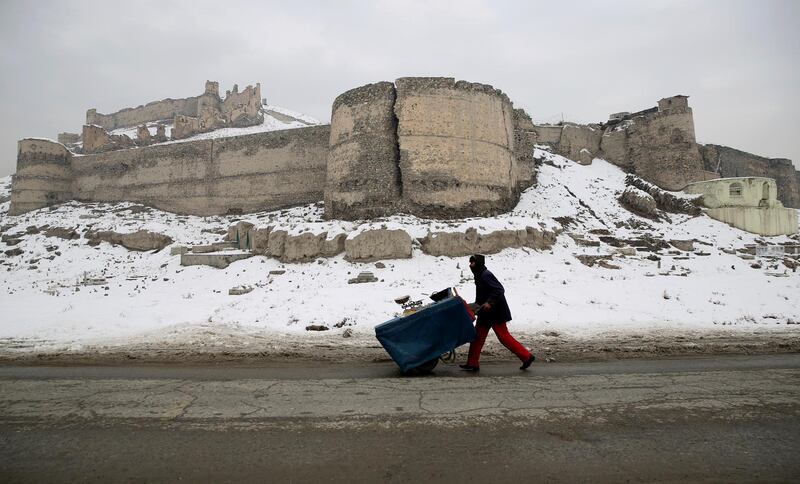An street vendor pulls his hand cart after a heavy snowfall in Kabul. AP Photo