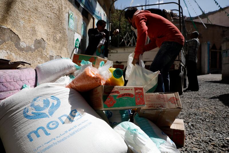 Conflict-affected people get free food rations provided by the Mona relief agency on World Food Day, in Sanaa, Yemen, in October. EPA