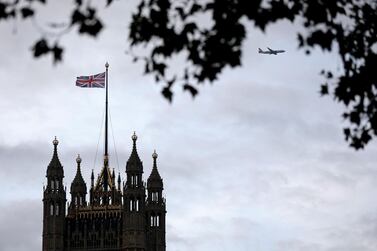 A Union flag flies from a pole atop the Victoria Tower at the Houses of Parliament in London. AFP