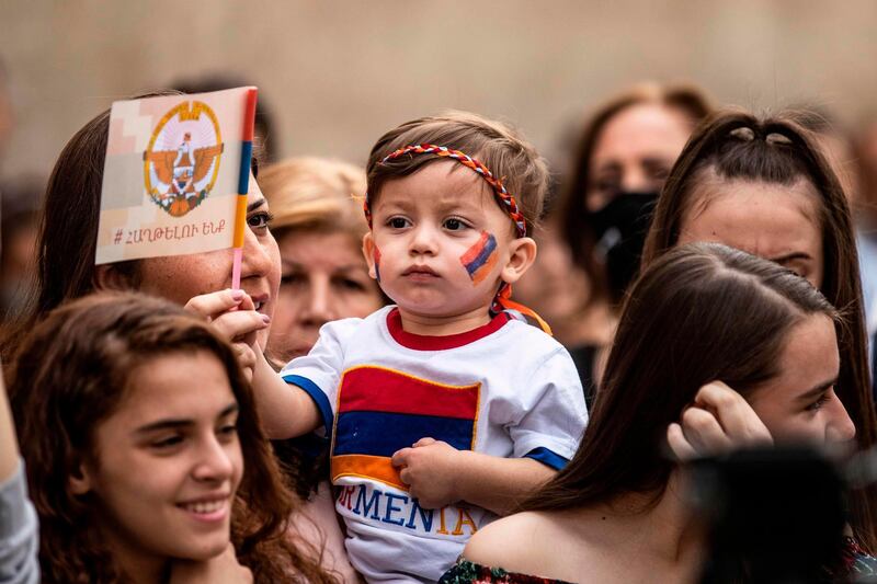 A young boy wears the colours of the Armenian flag as members of the Syrian Armenian minority take part in a rally in the Kurdish-majority city of Qamishli in Syria's northeastern Hasakeh province. AFP