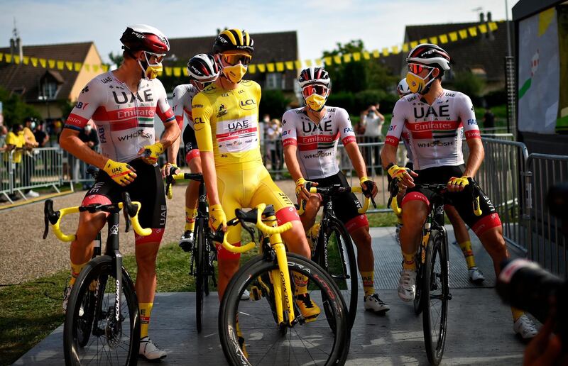 Slovenian rider Tadej Pogacar (2-nd L) of the UAE Team Emirates, flanked by teammates, wears the overall leader's yellow jersey as waiting for the start of the 21st and last stage of the Tour de France 2020 cycling race over 122km from Mantes-La-Jolie to Paris, France. EPA