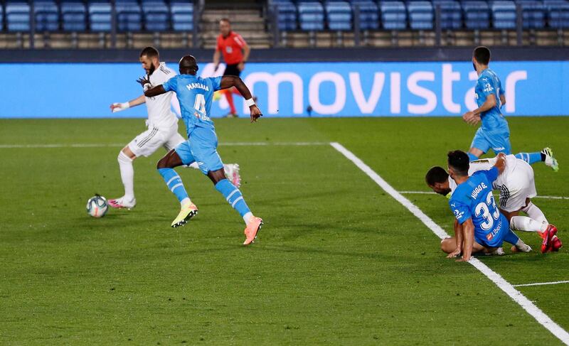 Real Madrid's Karim Benzema, left, scores his side's opening goal at the Alfredo di Stefano stadium. AP