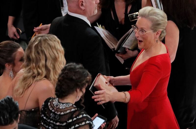 Meryl Streep gives Jennifer Lawrence a fly-by greeting. Reuters