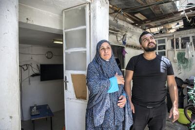 Motes Abu Khader,26, and his mother Nada.47, outside their hime in the Aida refugee camp near the Palestinian city of Bethlehem on June 23,2019. Photo by Heidi Levine for The National