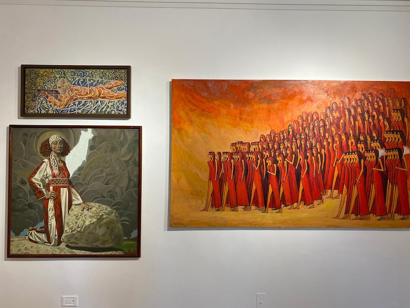 The artwork for sale includes a 1970 piece by Injy Efflatoun (top left), Walid Ebeid’s ‘Unruly Palestine’ (bottom left) and Alaa Awad’s ‘The Farewell’ (right). Nada El Sawy / The National 