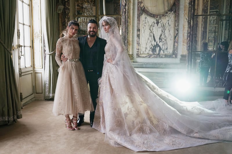 Zuhair Murad poses with models prior to his Haute Couture autumn/winter 2017-2018 show during Paris Fashion Week. Photo by Vittorio Zunino Celotto / Getty Images
