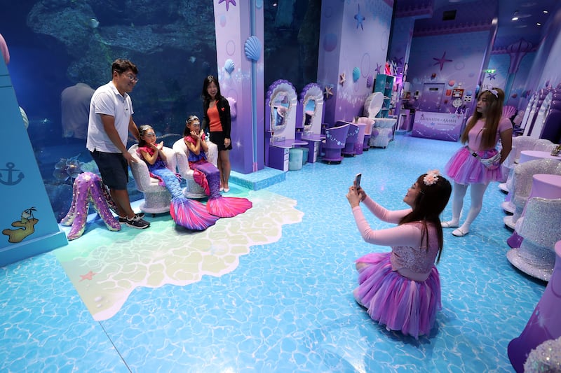 Luna, four, and Yuha, seven, pose for photos after their mermaid makeovers