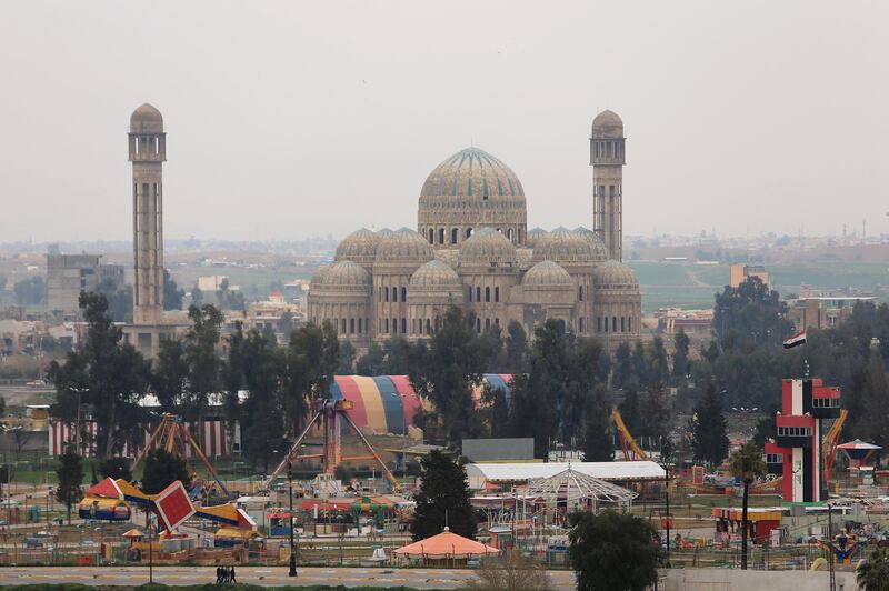 An amusement park with a Mosque in the background is seen in the Old City of Mosul, Iraq. Reuters